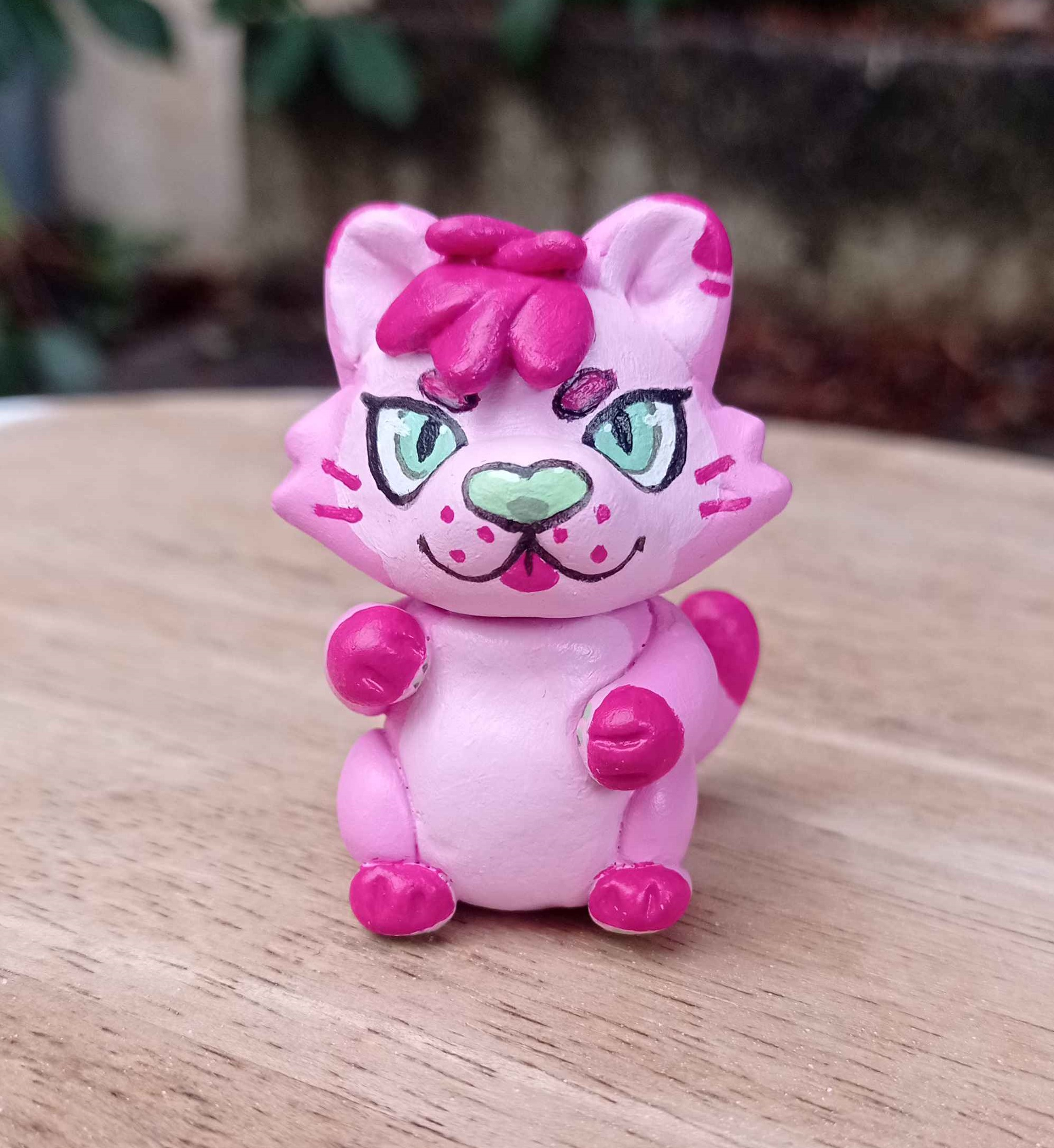 Tiny hand-made sculpture of a pink panther